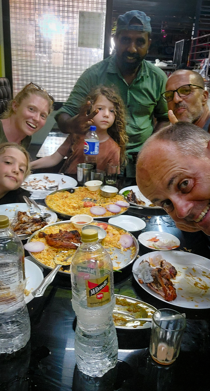 <span  class="uc_style_uc_tiles_grid_image_elementor_uc_items_attribute_title" style="color:#ffffff;">Travel family in their favourite local restaurant called 'Fathima'</span>